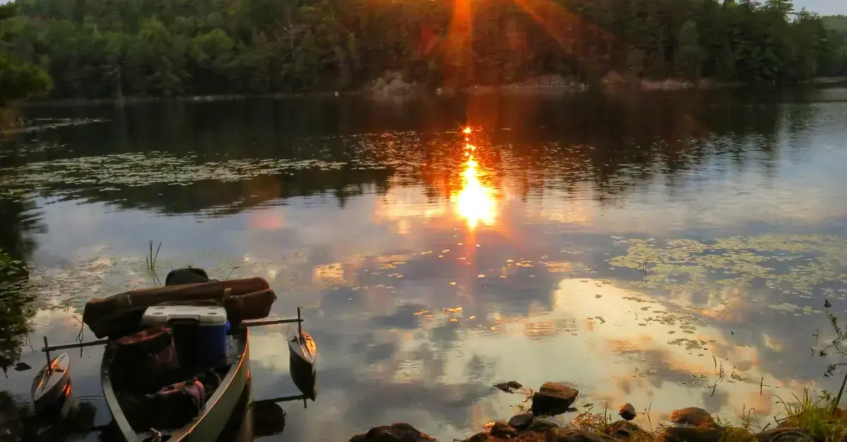 Scenic Adirondack river surrounded by rocky banks and colorful forest trees.
