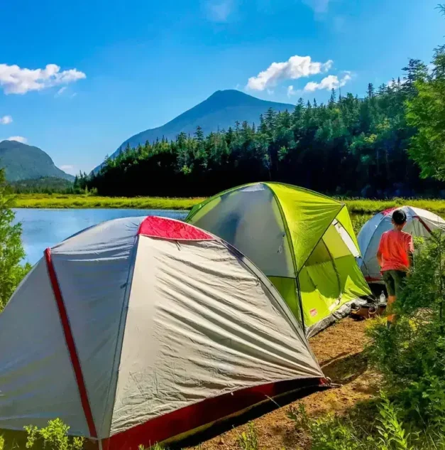 Tent set up in a scenic mountain campsite during a summer trip