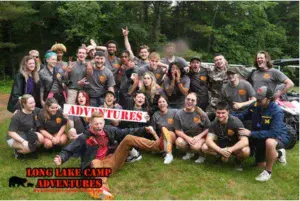 Long Lake Camp Adventures staff group celebrating outdoors during <a href=