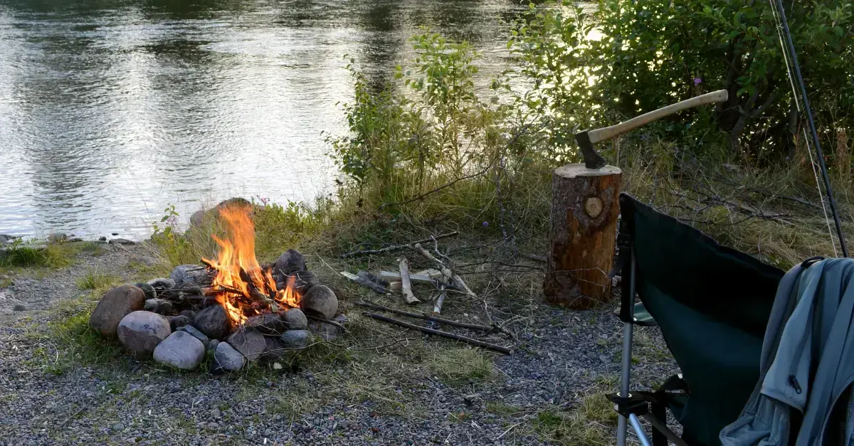 Campfire by the lakeside at Long Lake Camp Adventures’ fishing summer camp.
